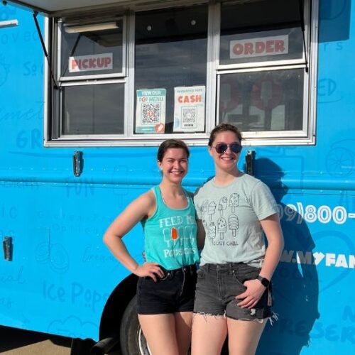 girls in front of truck