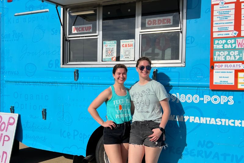 girls in front of truck